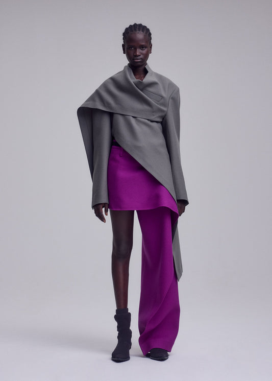A model wears the ISSEY MIYAKE CALLIGRAPH jacket.