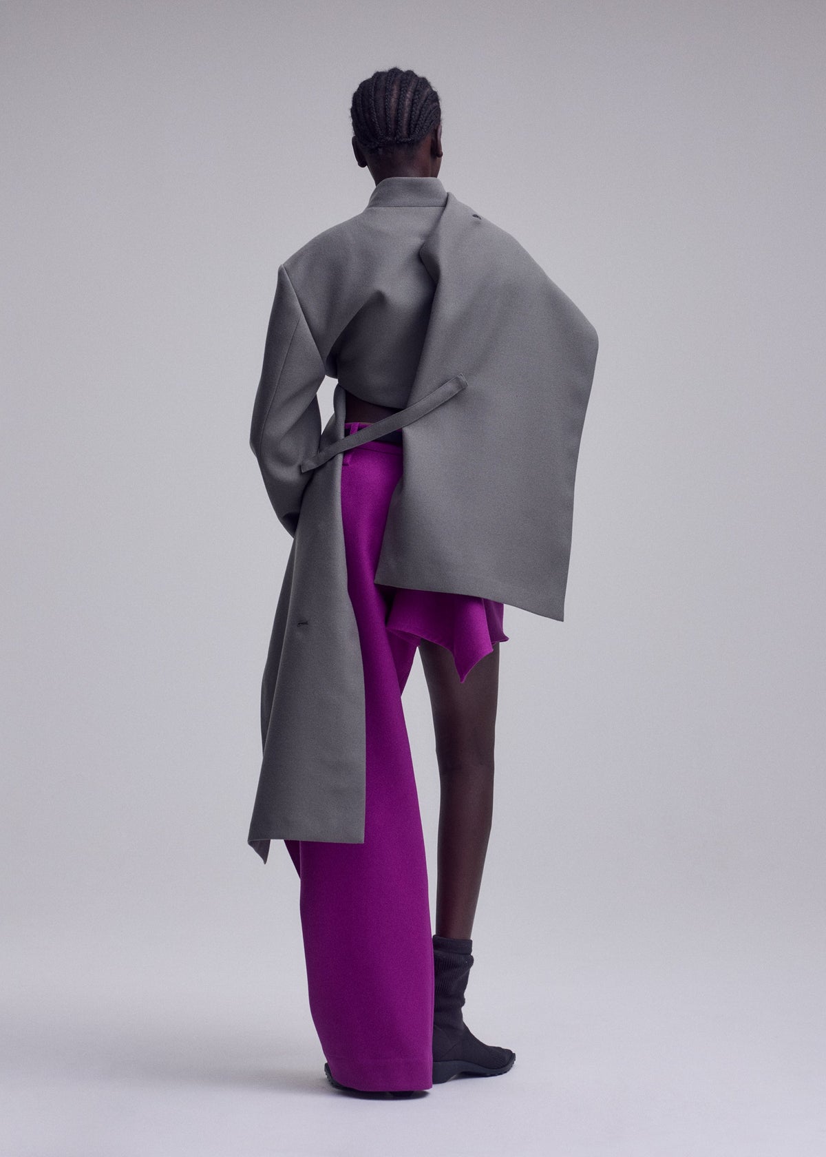 A model wears the ISSEY MIYAKE CALLIGRAPH jacket.
