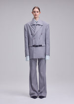 A model wears the ISSEY MIYAKE HONEST ENSEMBLE honest-ensemble-jacket-grey.