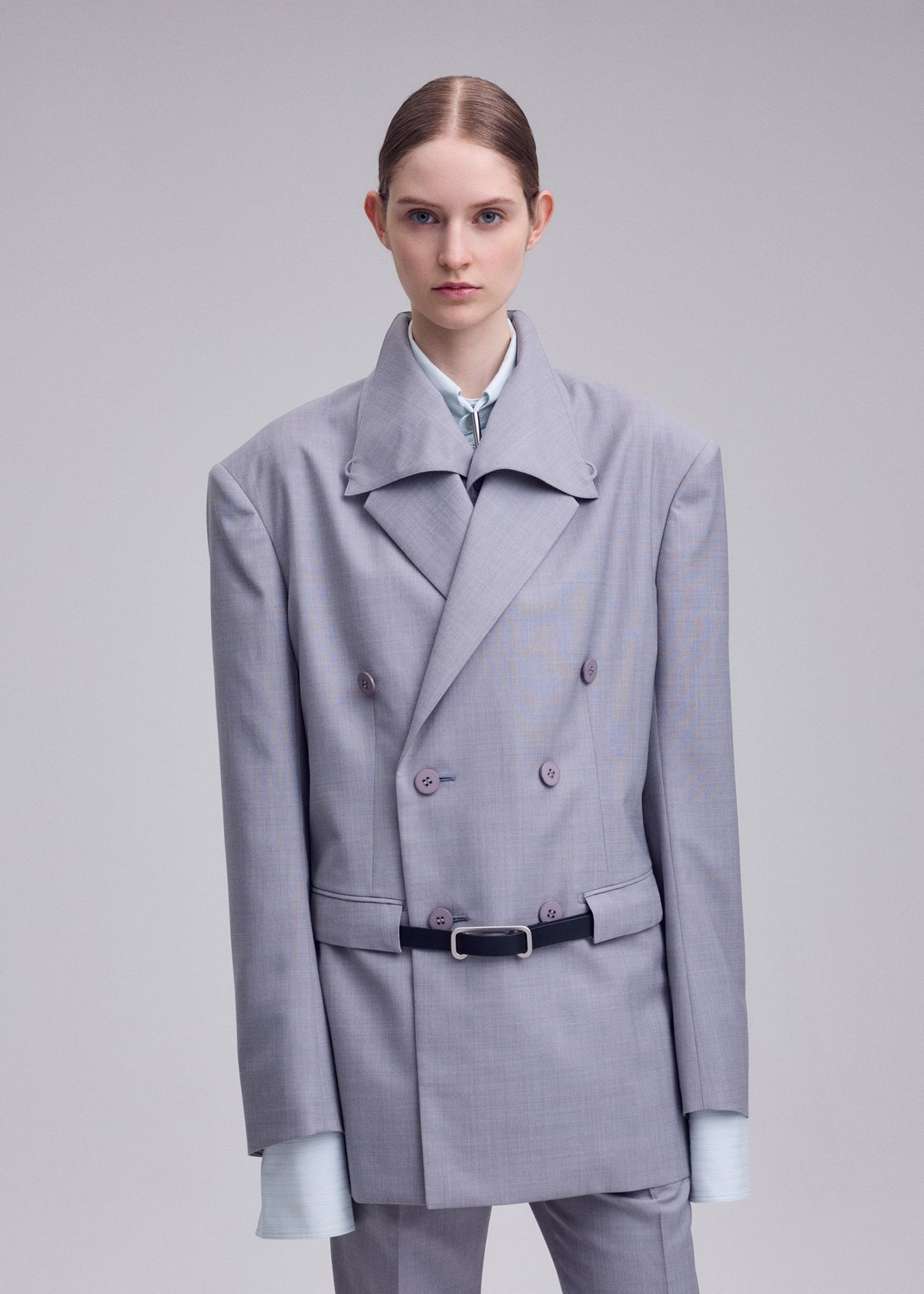 A model wears the ISSEY MIYAKE HONEST ENSEMBLE honest-ensemble-jacket-grey.