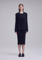 A model wears the ISSEY MIYAKE HATCHING PLEATS hatching-pleats-jacket-grey.