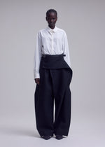 A model wears the ISSEY MIYAKE CALLIGRAPH trousers.