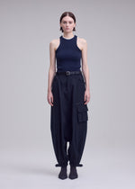 A model wears the ISSEY MIYAKE GRAINY PANTS grainy-trousers-trousers-black-1.