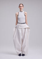 A model wears the ISSEY MIYAKE GRAINY PANTS grainy-trousers-trousers-off-white-2.