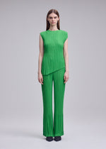 A model wears the ISSEY MIYAKE UNFURLING PLEATS unfurling-pleats-trousers-green-1.