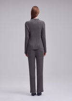 A model wears the ISSEY MIYAKE HATCHING PLEATS trousers.