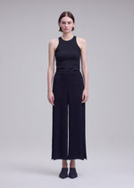 A model wears the ISSEY MIYAKE HATCHING BOTTOMS hatching-bottoms-trousers-dark-navy-1.