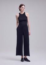 A model wears the ISSEY MIYAKE HATCHING BOTTOMS hatching-bottoms-trousers-dark-navy-1.