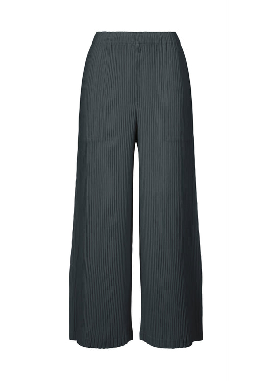 A product shot of the ISSEY MIYAKE HATCHING BOTTOMS pants in dark navy.
