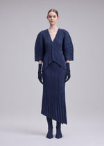 A model wears the ISSEY MIYAKE UNFURLING PLEATS unfurling-pleats-skirt-green-1.