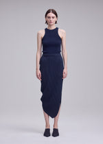 A model wears the ISSEY MIYAKE LEAF PLEATS leaf-pleats-skirt-dark-navy.