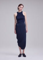 A model wears the ISSEY MIYAKE LEAF PLEATS leaf-pleats-skirt-off-white.