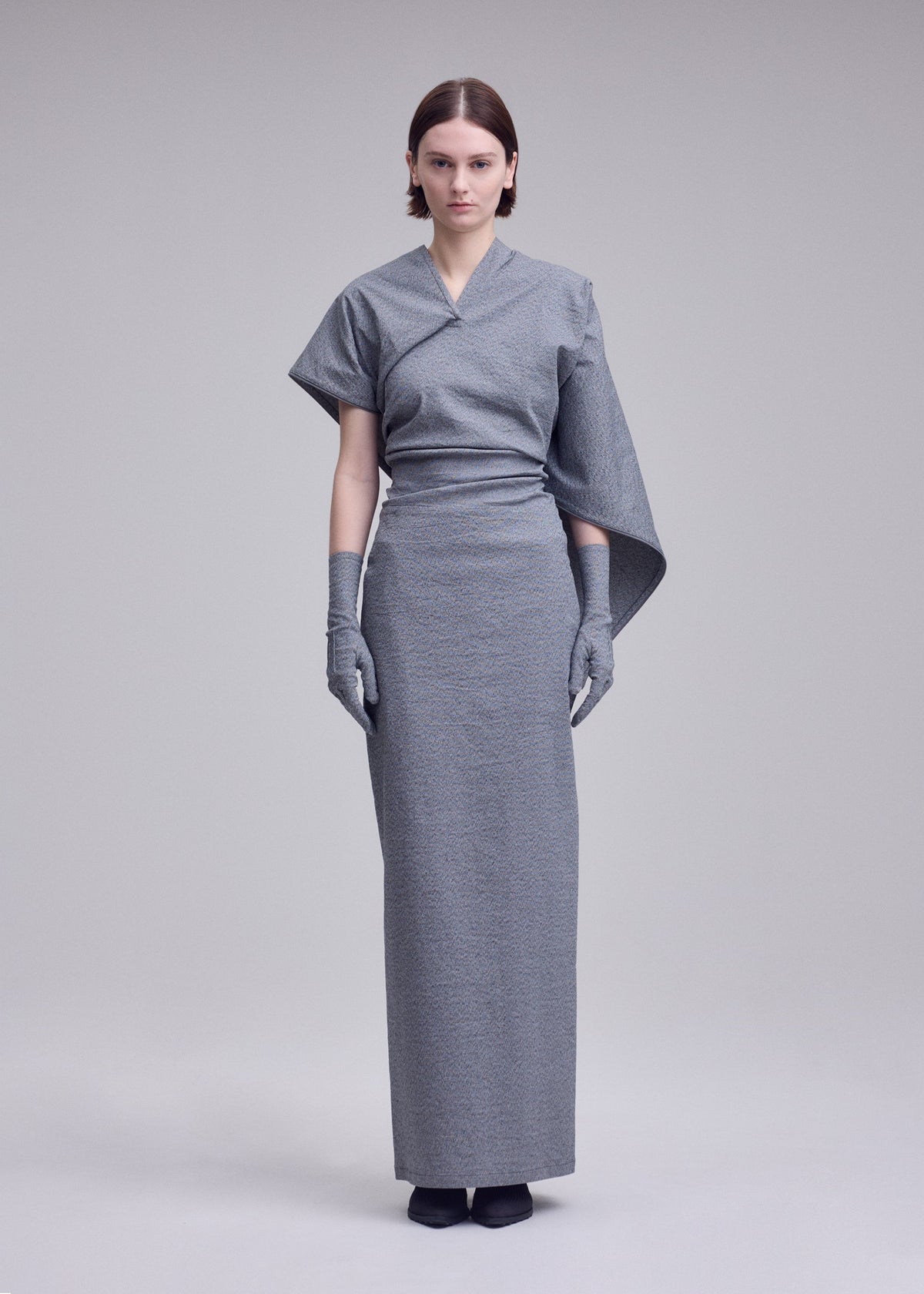 A model wears the ISSEY MIYAKE ALLOW allow-dress-off-white.