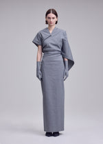 A model wears the ISSEY MIYAKE ALLOW allow-dress-dark-navy-2.