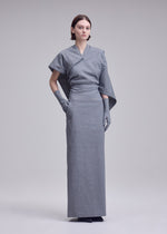 A model wears the ISSEY MIYAKE ALLOW allow-dress-dark-navy-2.