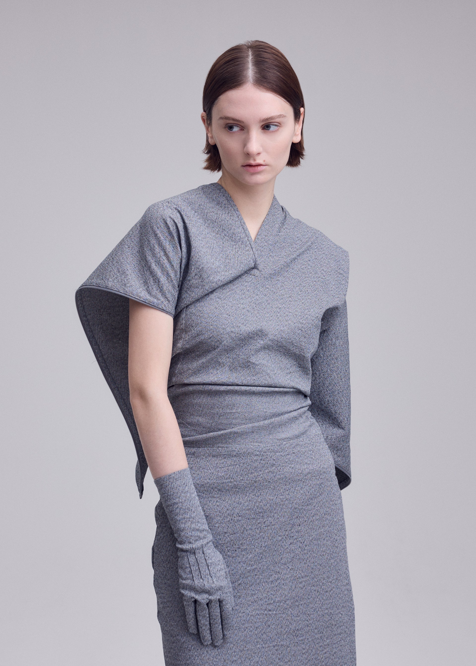 A model wears the ISSEY MIYAKE ALLOW allow-dress-dark-navy-2.