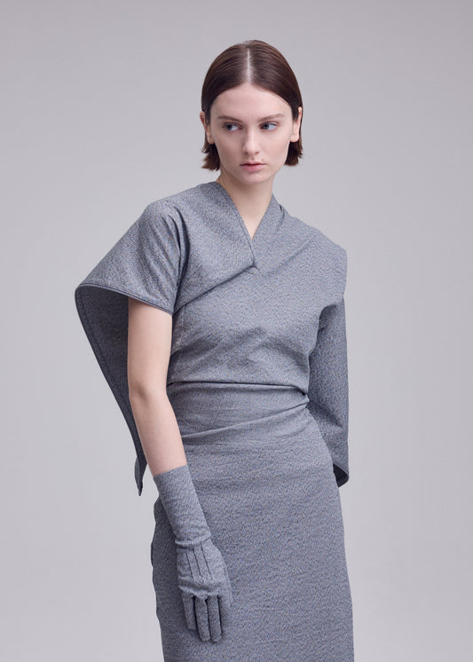 A model wears the ISSEY MIYAKE ALLOW allow-dress-dark-navy-2.
