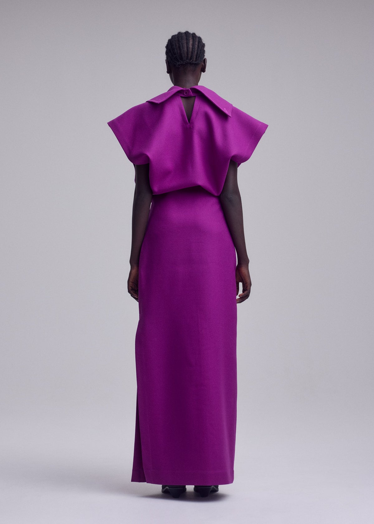 A model wears the ISSEY MIYAKE CALLIGRAPH dress.