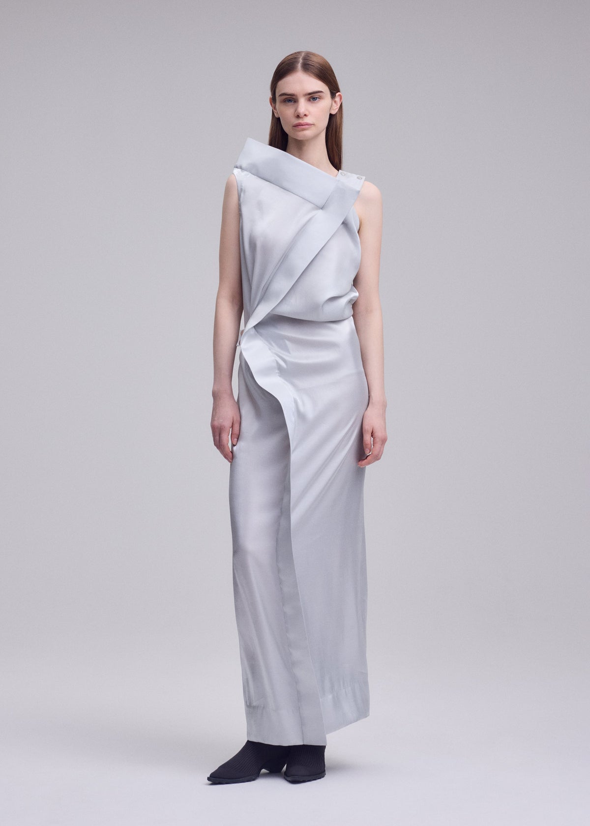 A model wears the ISSEY MIYAKE MERCURY mercury-dress-light-grey.