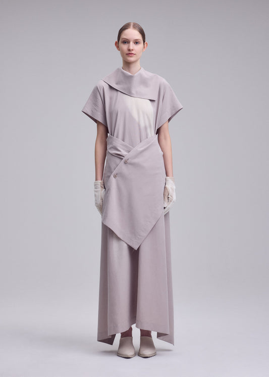 A model wears the ISSEY MIYAKE HANDS OF LOVER dress.