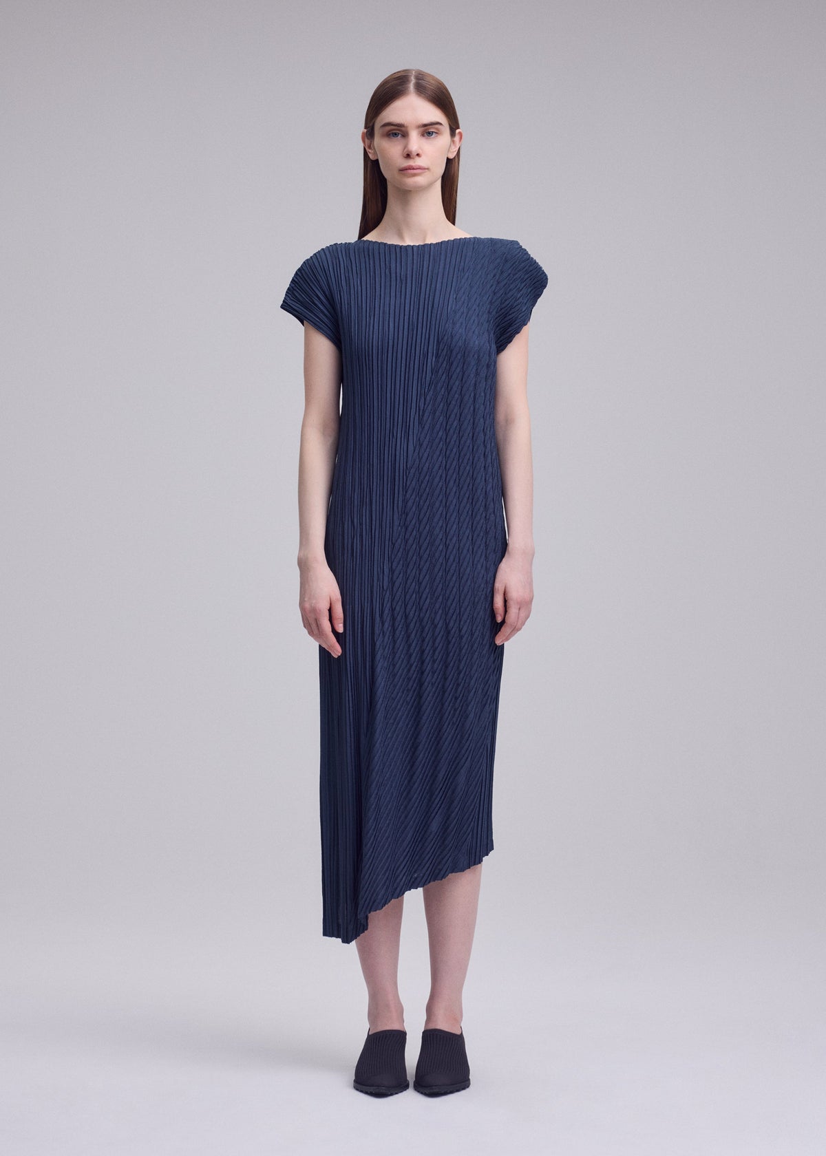 A model wears the ISSEY MIYAKE UNFURLING PLEATS unfurling-pleats-dress-green-1.