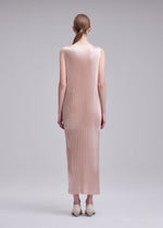 A model wears the ISSEY MIYAKE GLOSSED PANELS PLEATS dress.