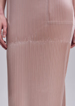 A model wears the ISSEY MIYAKE GLOSSED PANELS PLEATS dress.