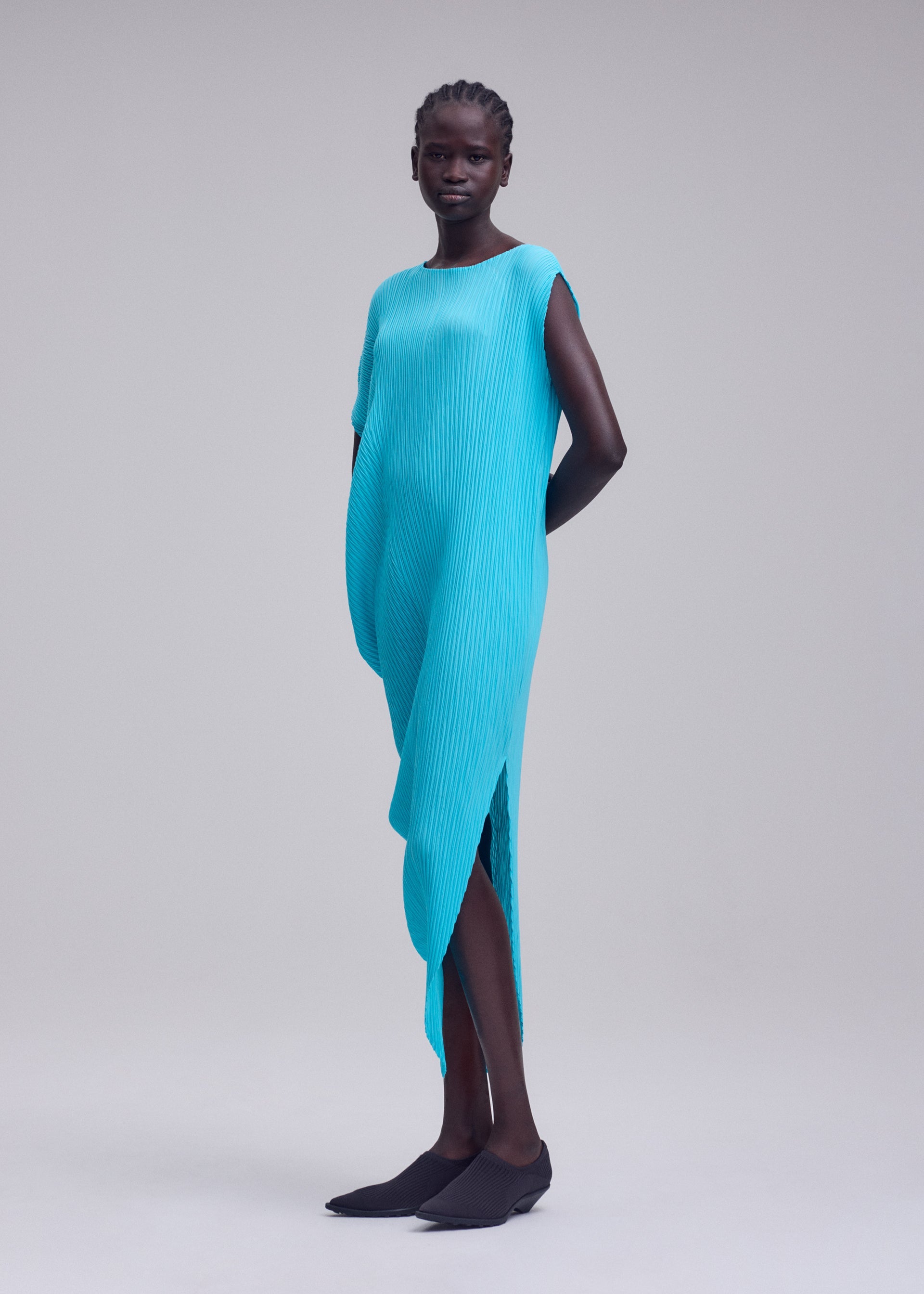 A model wears the ISSEY MIYAKE LEAF PLEATS leaf-pleats-dress-dark-navy.