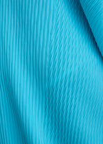 A model wears the ISSEY MIYAKE LEAF PLEATS leaf-pleats-dress-dark-navy.