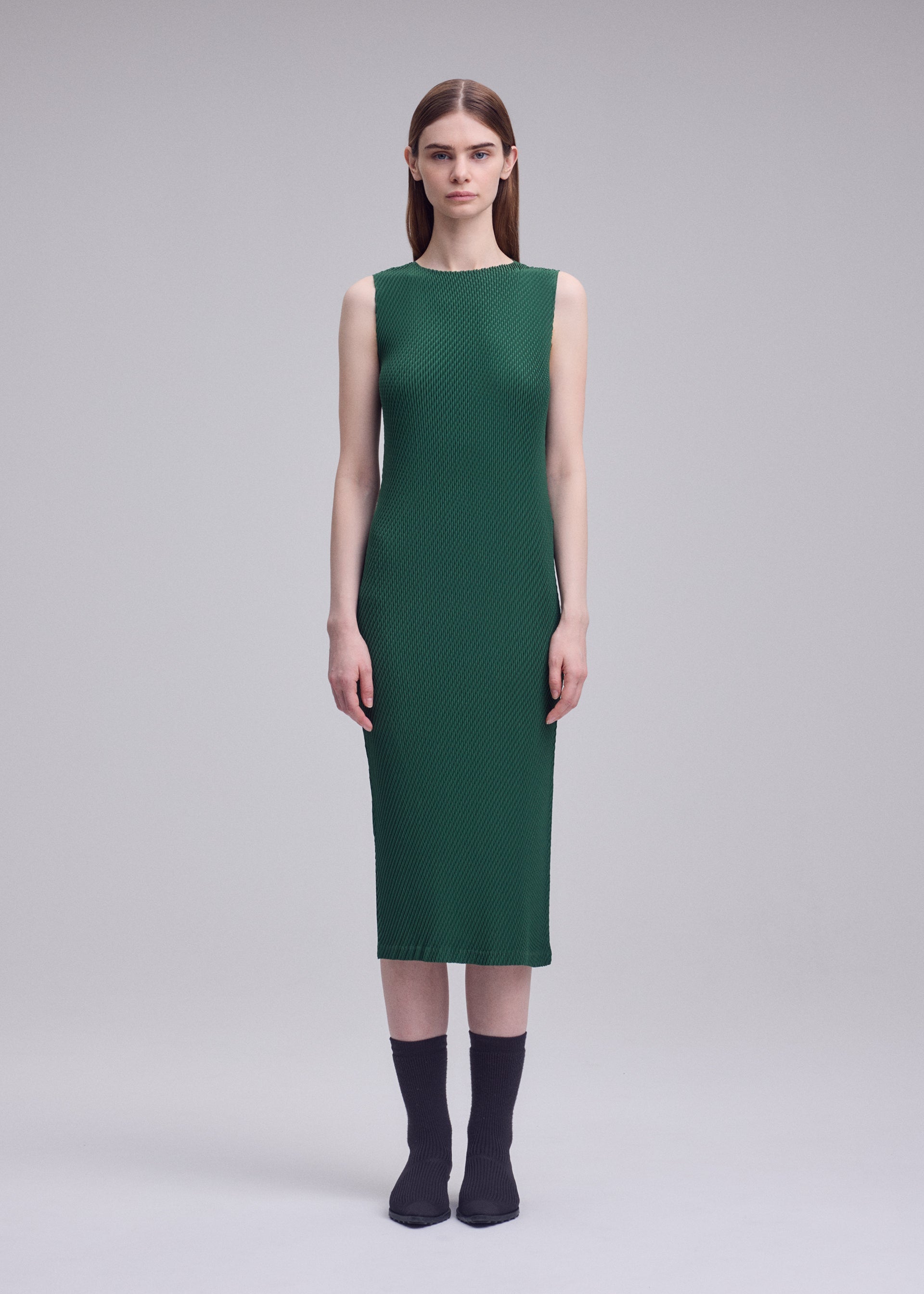 A model wears the ISSEY MIYAKE RHOMBUS PLEATS rhombus-pleats-dress.