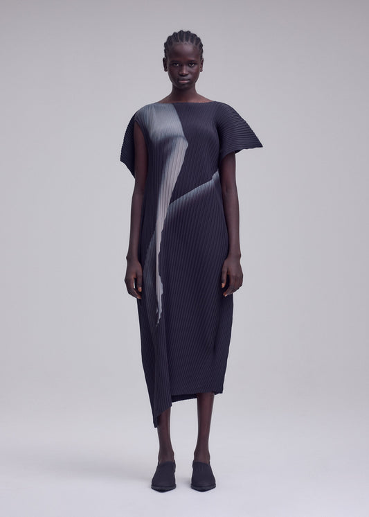 A model wears the ISSEY MIYAKE HANDS OF LOVER PLEATS dress.