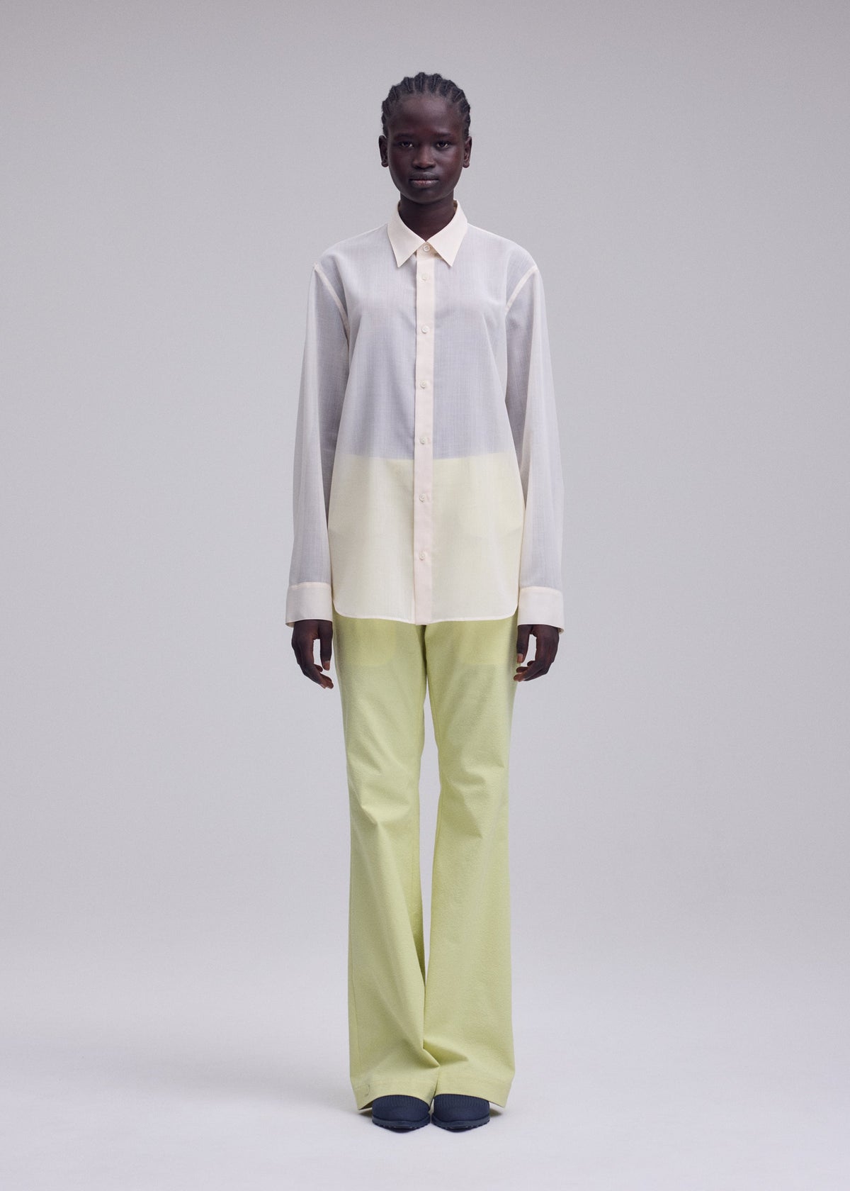 A model wears the ISSEY MIYAKE SHEER WOOL sheer-wool-shirt-off-white.