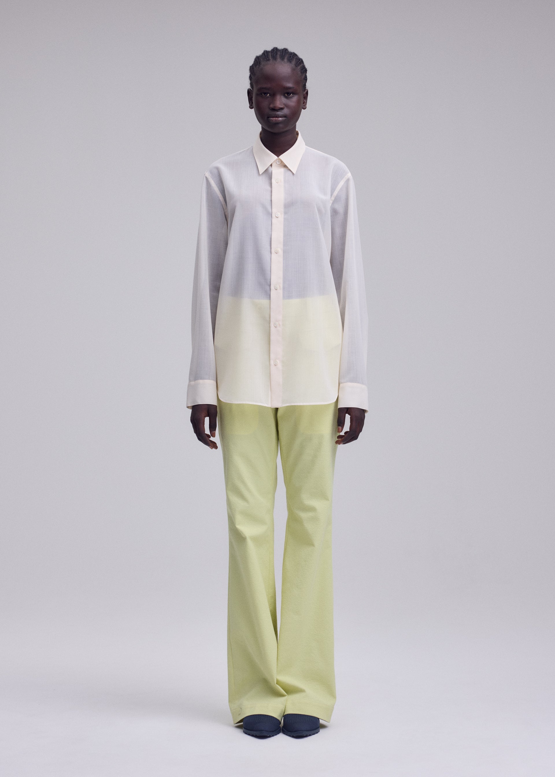 A model wears the ISSEY MIYAKE SHEER WOOL sheer-wool-shirt-off-white.