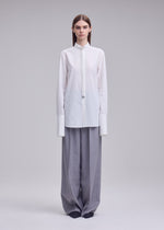 A model wears the ISSEY MIYAKE MONSIEUR SHIRT monsieur-shirt-shirt-black.