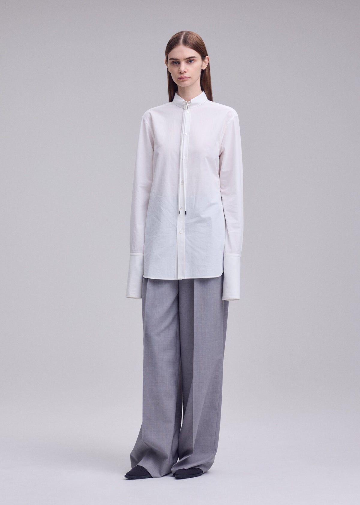 A model wears the ISSEY MIYAKE MONSIEUR SHIRT monsieur-shirt-shirt-black.