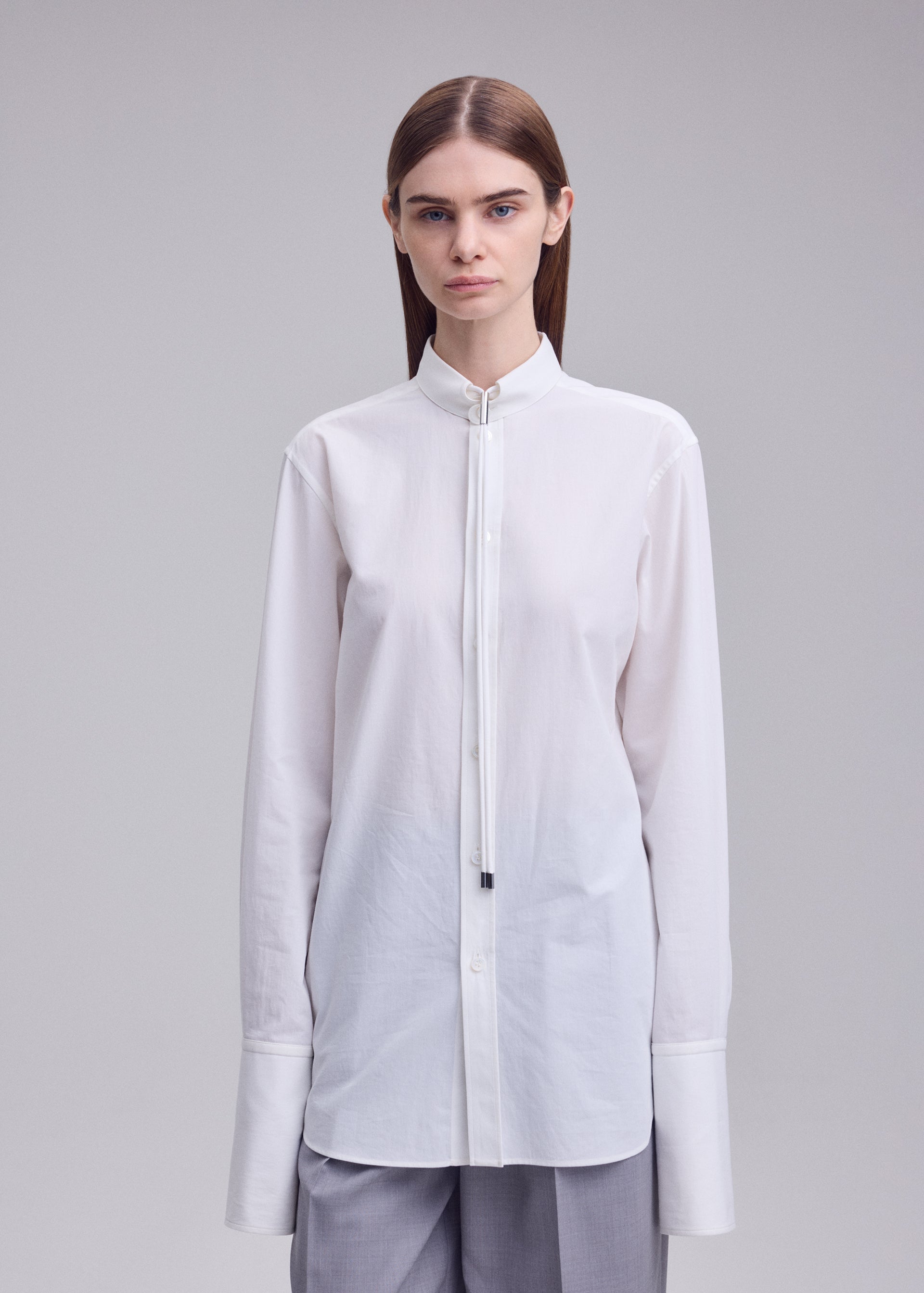 A model wears the ISSEY MIYAKE MONSIEUR SHIRT monsieur-shirt-shirt-white.
