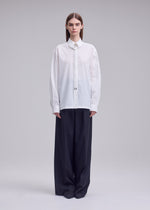 A model wears the ISSEY MIYAKE MONSIEUR SHIRT monsieur-shirt-shirt-white-1.