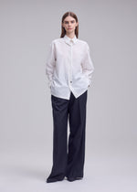 A model wears the ISSEY MIYAKE MONSIEUR SHIRT monsieur-shirt-shirt-white-1.
