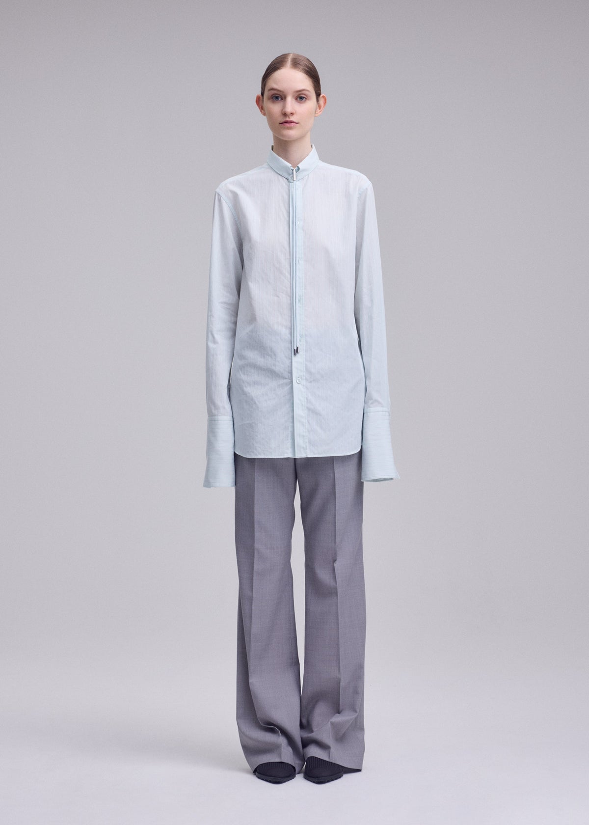 A model wears the ISSEY MIYAKE MONSIEUR SHIRT(DOBBY STRIPE) monsieur-shirt-dobby-stripe-shirt-blue-hued.