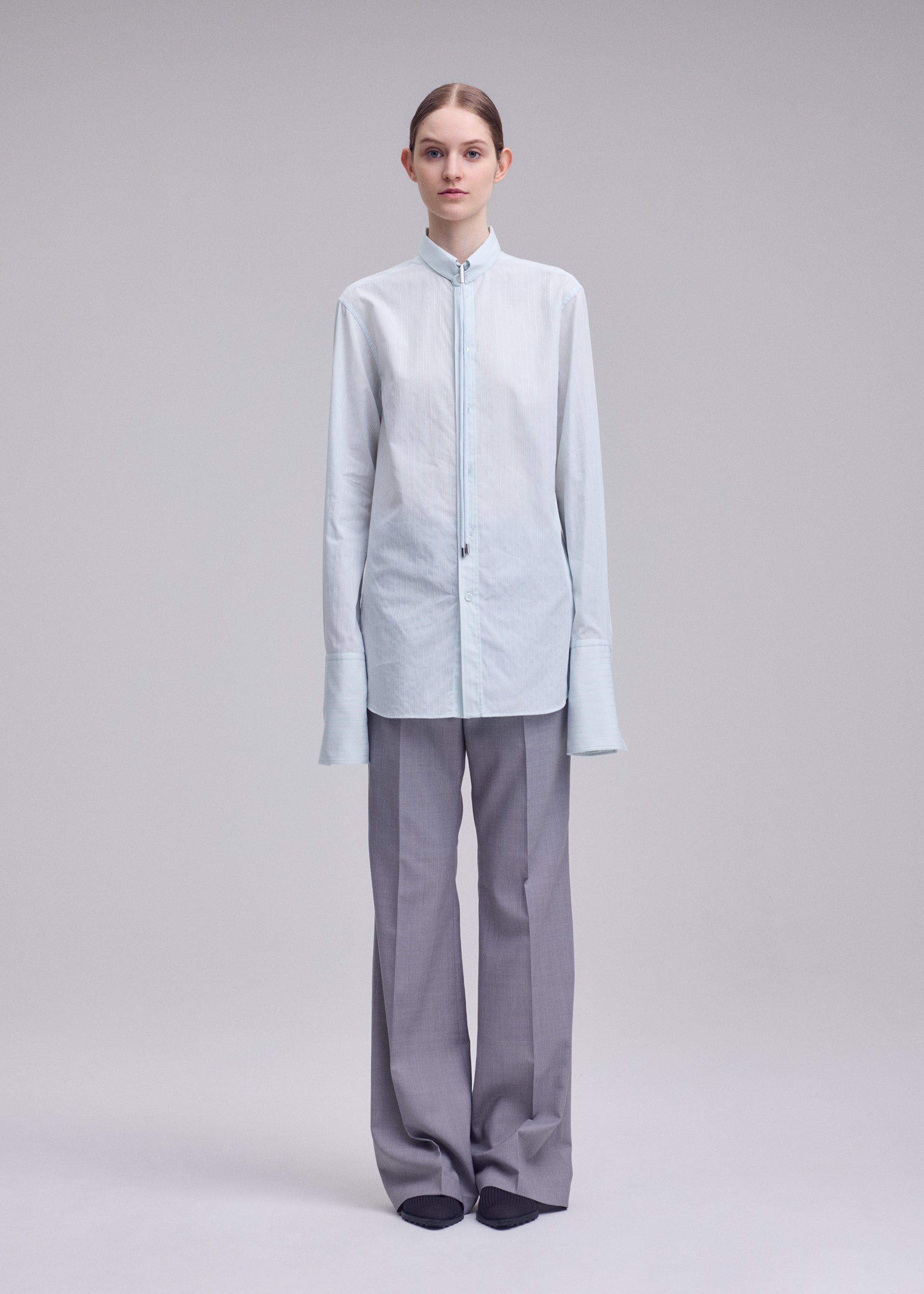 A model wears the ISSEY MIYAKE MONSIEUR SHIRT(DOBBY STRIPE) monsieur-shirt-dobby-stripe-shirt-black-hued.