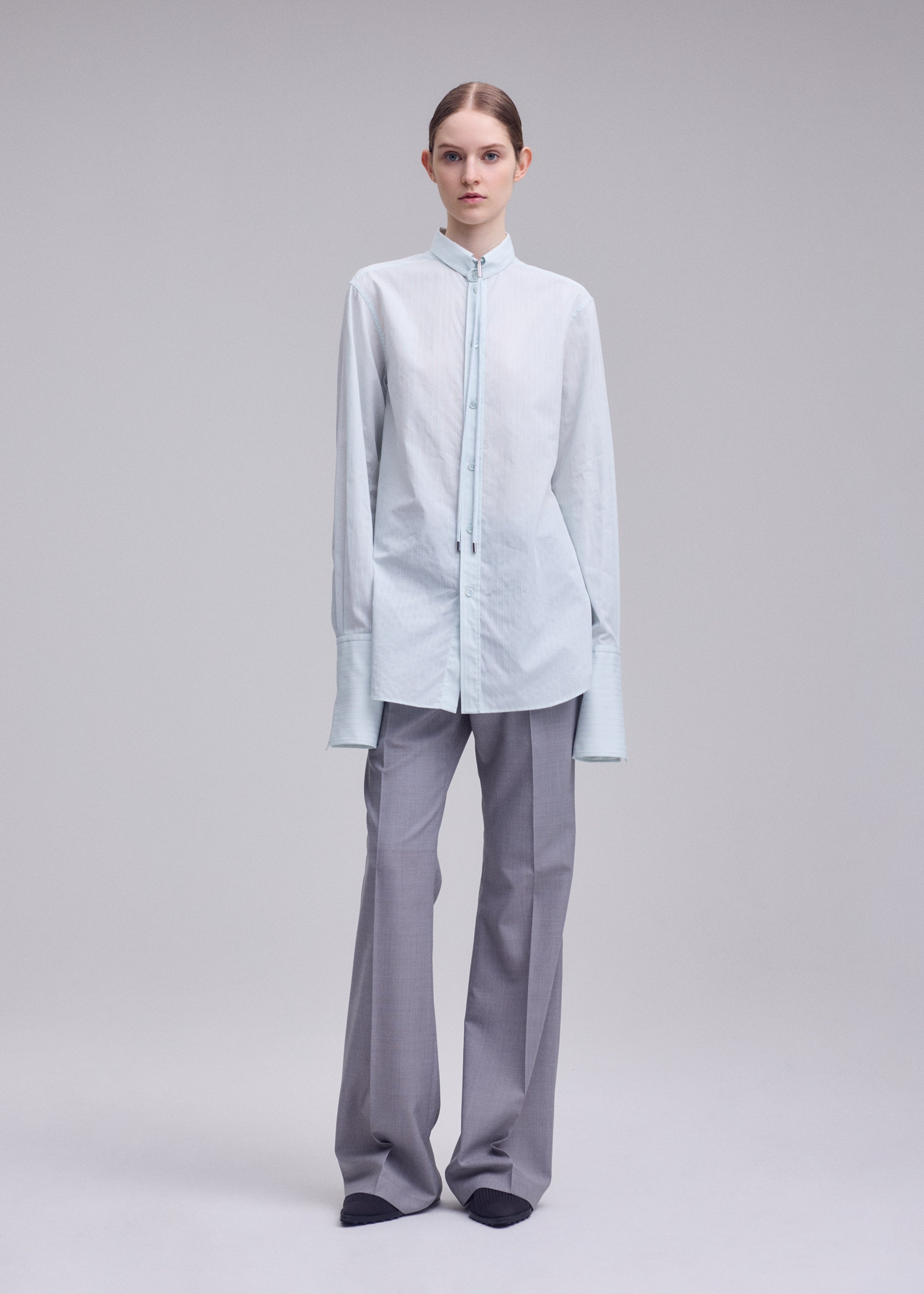 A model wears the ISSEY MIYAKE MONSIEUR SHIRT(DOBBY STRIPE) monsieur-shirt-dobby-stripe-shirt-black-hued.