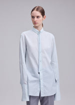 A model wears the ISSEY MIYAKE MONSIEUR SHIRT(DOBBY STRIPE) monsieur-shirt-dobby-stripe-shirt-blue-hued.
