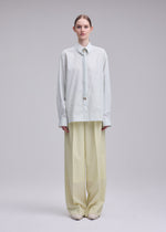 A model wears the ISSEY MIYAKE MONSIEUR SHIRT(DOBBY STRIPE) monsieur-shirt-dobby-stripe-shirt-blue-hued-1.