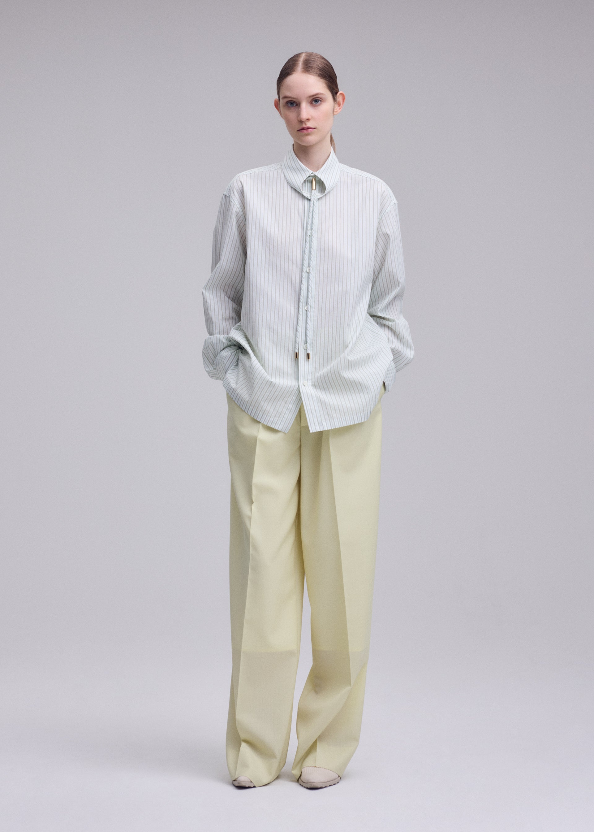 A model wears the ISSEY MIYAKE MONSIEUR SHIRT(DOBBY STRIPE) monsieur-shirt-dobby-stripe-shirt-black-hued-1.