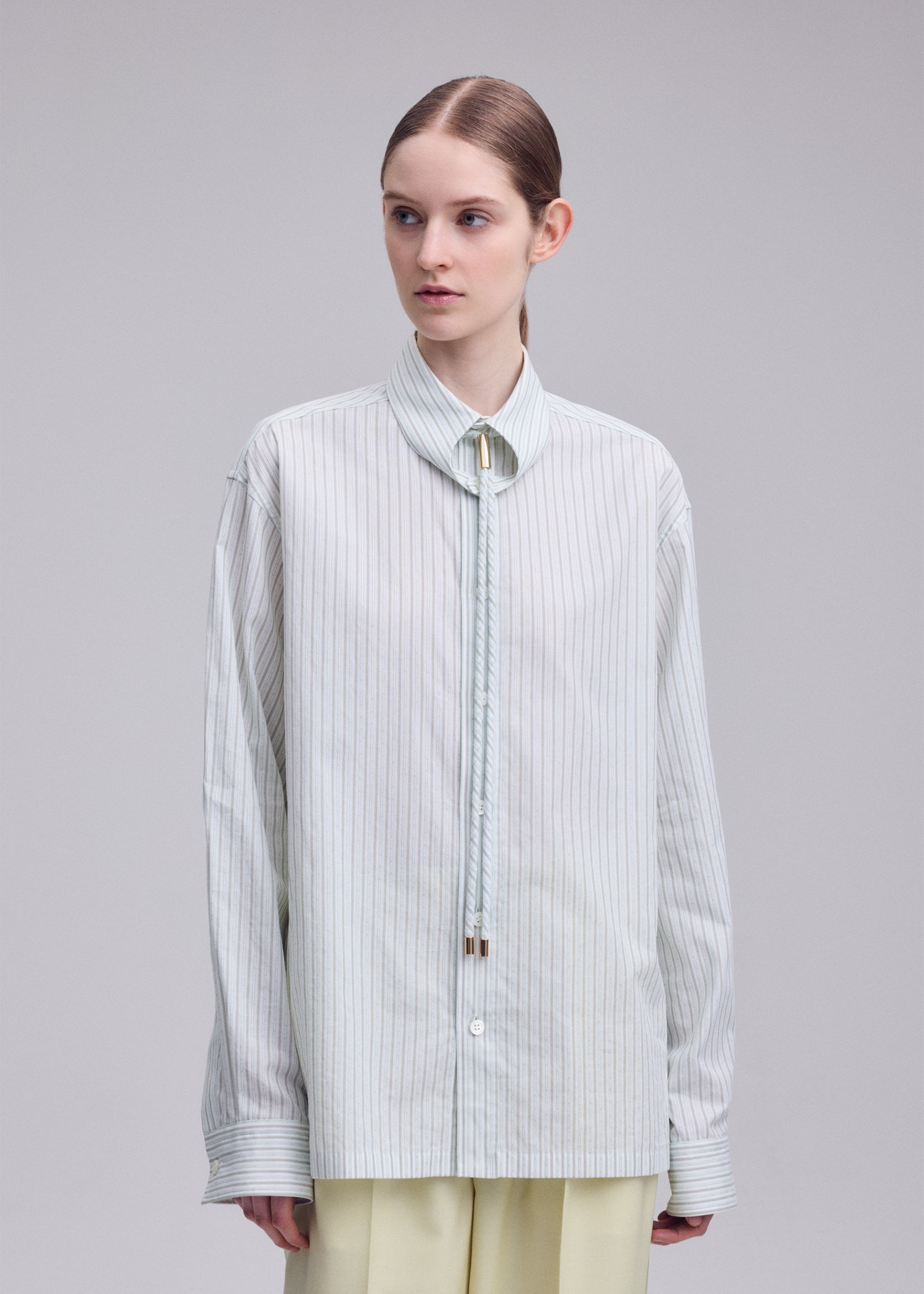 A model wears the ISSEY MIYAKE MONSIEUR SHIRT(DOBBY STRIPE) monsieur-shirt-dobby-stripe-shirt-blue-hued-1.