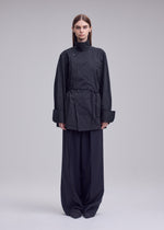 A model wears the ISSEY MIYAKE MONSIEUR SHIRT(DOBBY STRIPE) monsieur-shirt-dobby-stripe-shirt-white-hued.