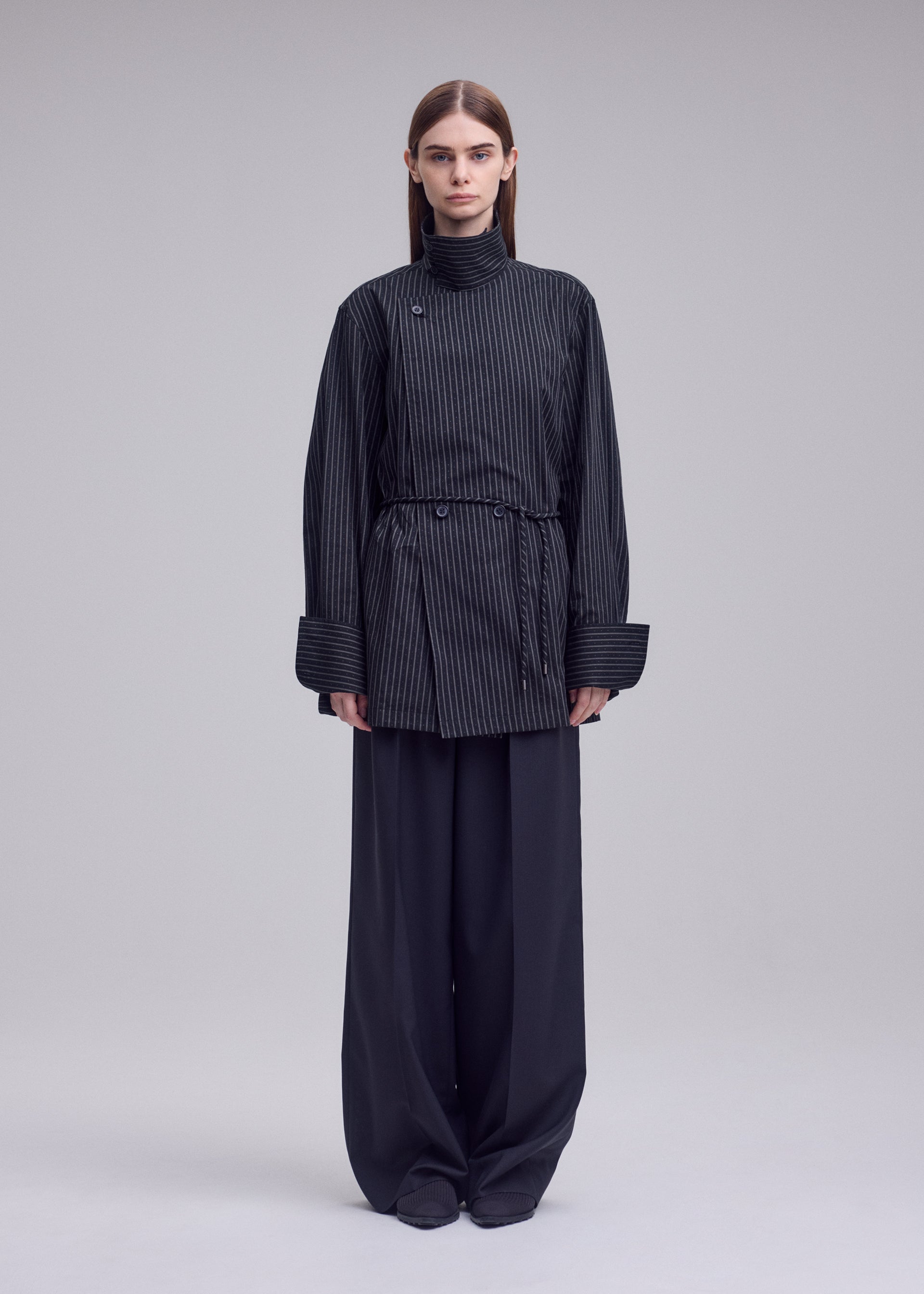 A model wears the ISSEY MIYAKE MONSIEUR SHIRT(DOBBY STRIPE) monsieur-shirt-dobby-stripe-shirt-white-hued.