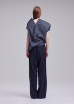 A model wears the ISSEY MIYAKE REFLECTION shirt.