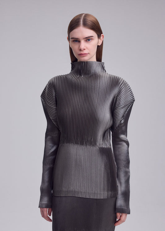 A model wears the ISSEY MIYAKE GLOSSED PANELS PLEATS shirt.