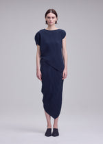 A model wears the ISSEY MIYAKE LEAF PLEATS leaf-pleats-shirt-off-white.